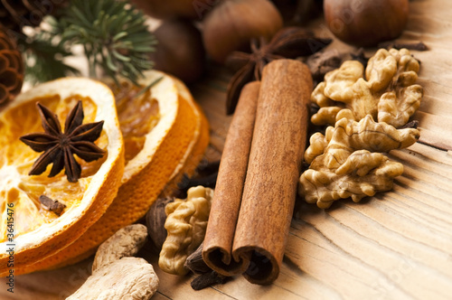 Different kinds of spices, nuts and dried oranges - christmas de