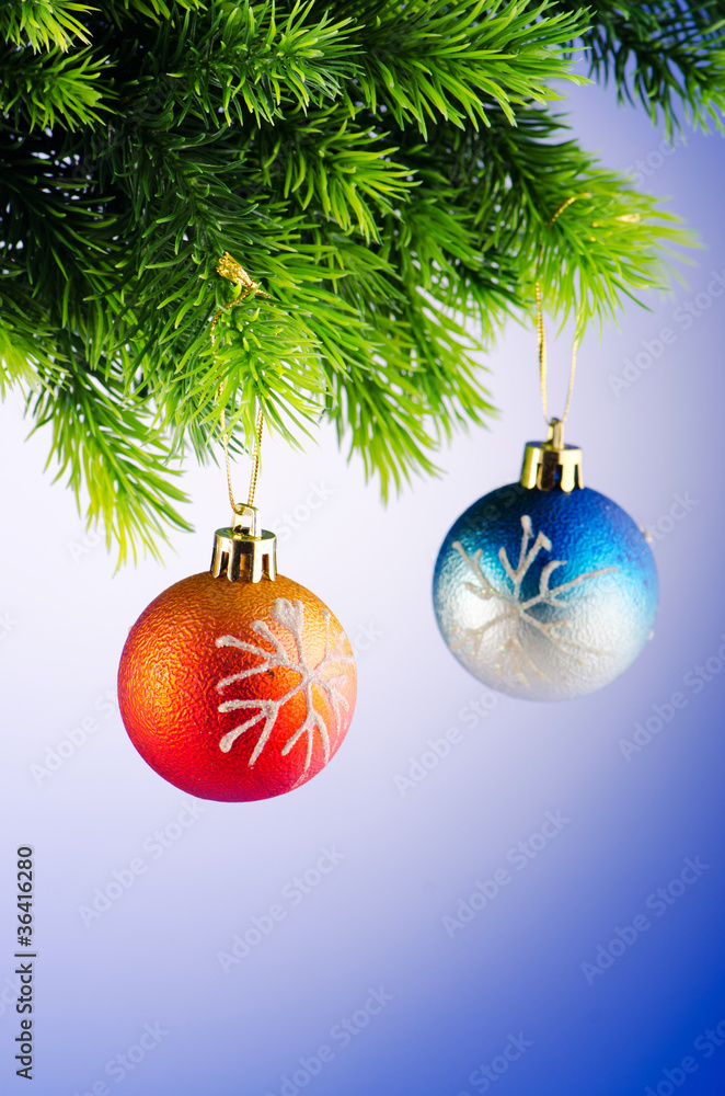 Baubles on christmas tree in celebration concept