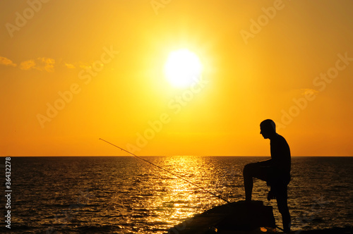 Fisherman at sunset © dekanaryas