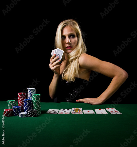 Attractive young woman playing poker