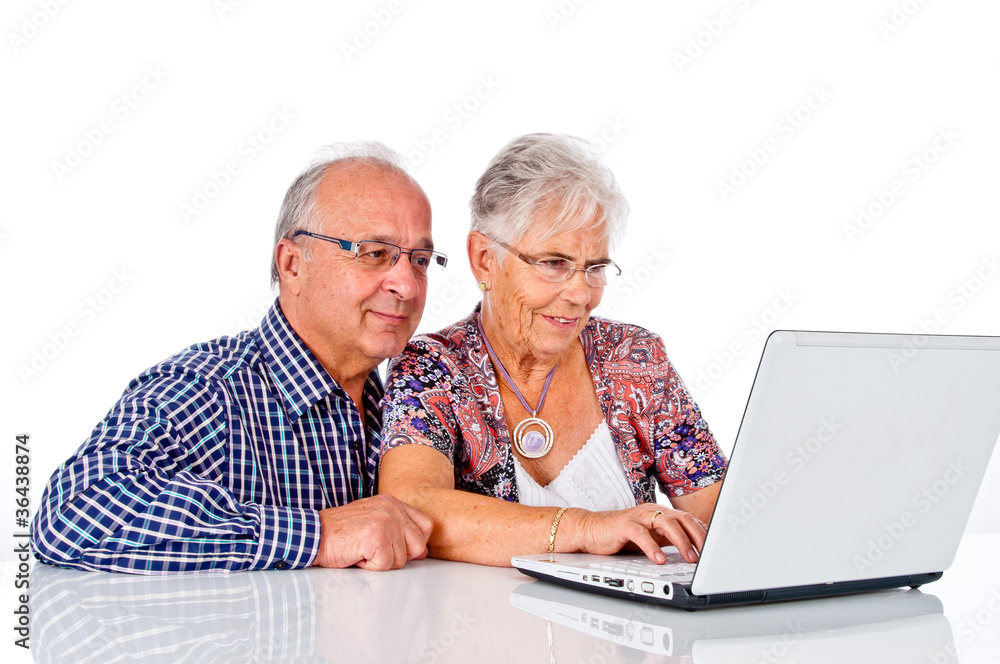 Senior man and woman using a computer laptop Senior man and woman using a computer laptop