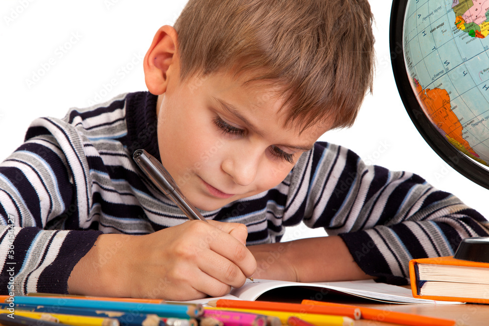 Cute schoolboy is writting Cute schoolboy is writting