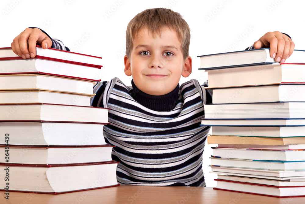 Schoolboy and a heap of books isolated on a white background Schoolboy and a heap of books isolated on a white background