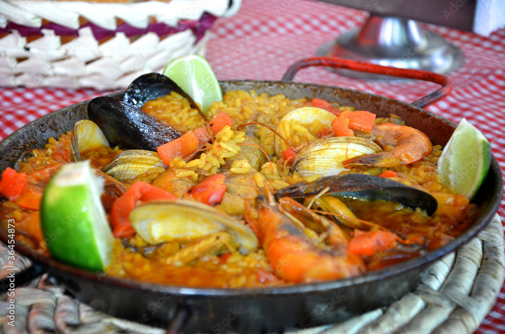Spanish paella in pan on table