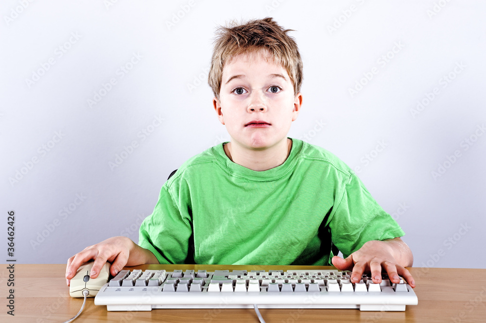 boy is looking stupefying in to the computermonitor boy is looking stupefying in to the computermonitor