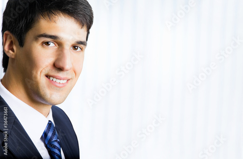 Portrait happy smiling business man at office