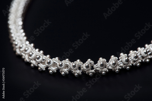 Sterling silver necklace close-up over dark background