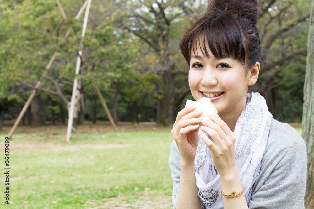 Beautiful young woman eating lunch in the forest Beautiful young woman eating lunch in the forest