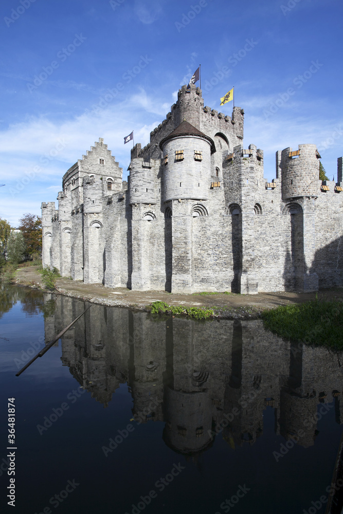 Gravensteen castle in Gand reflects in the water.
