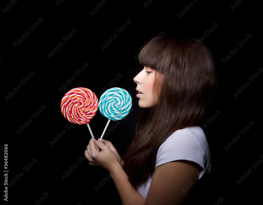 .young woman with lollipop, black background .young woman with lollipop, black background