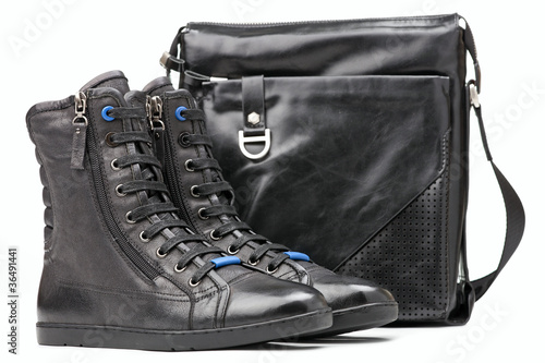Pair of black ankle-high men boots and shoulder bag