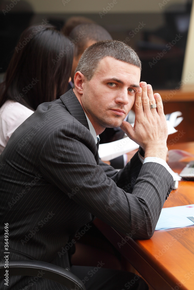 Serious mature businessman in business meeting at office Serious mature businessman in business meeting at office