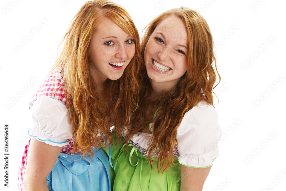 zwei lachende frauen in dirndl auf weissem hintergrund zwei lachende frauen in dirndl auf weissem hintergrund