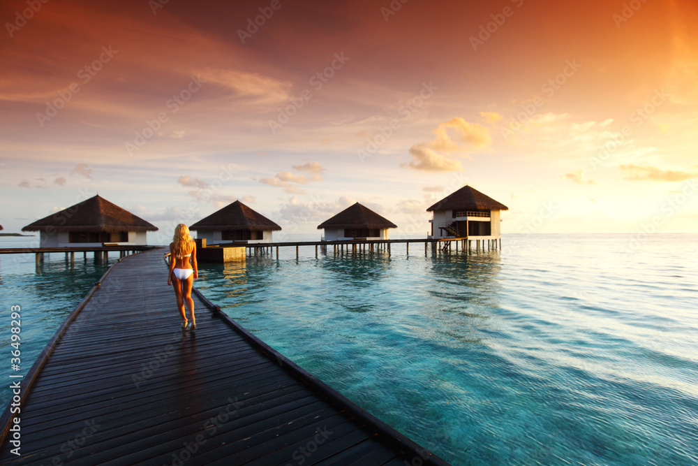 woman in a dress on maldivian sunset