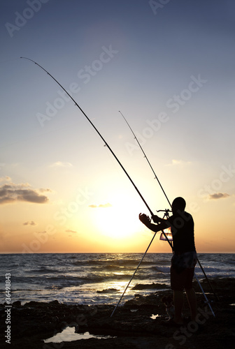 Silhouette of Man Fishing at Sunset