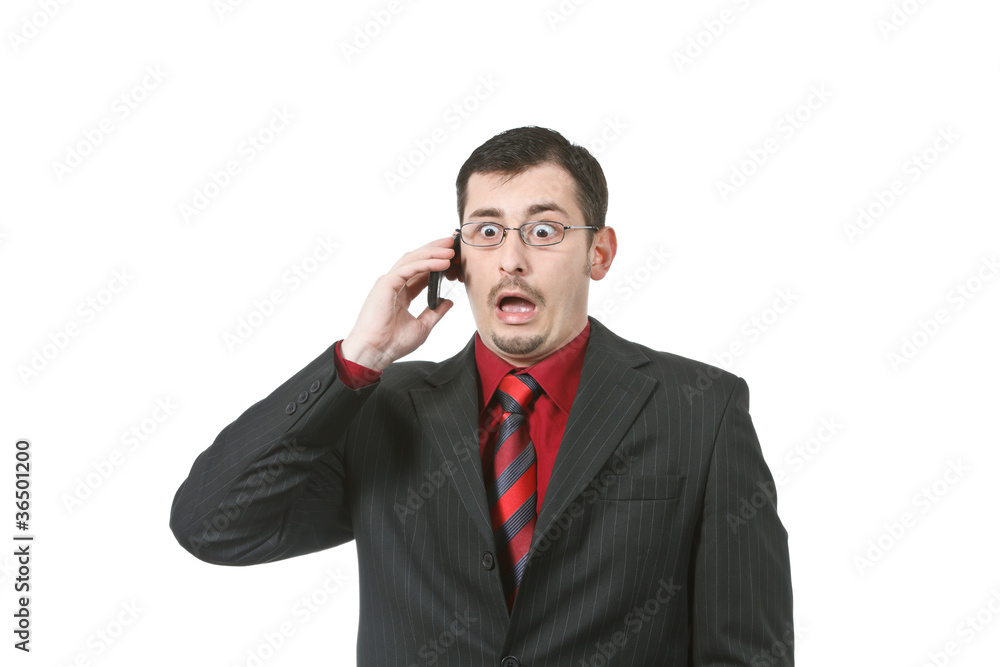 Businessman scared while talking on a cell phone Businessman scared while talking on a cell phone