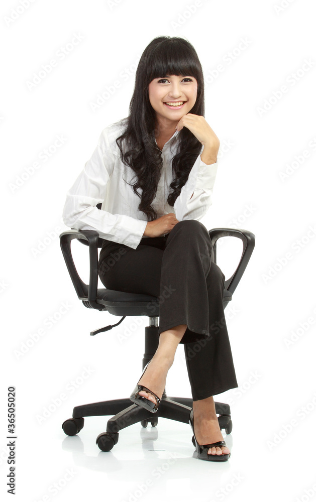 Portrait of beautiful young woman sitting on chair Portrait of beautiful young woman sitting on chair