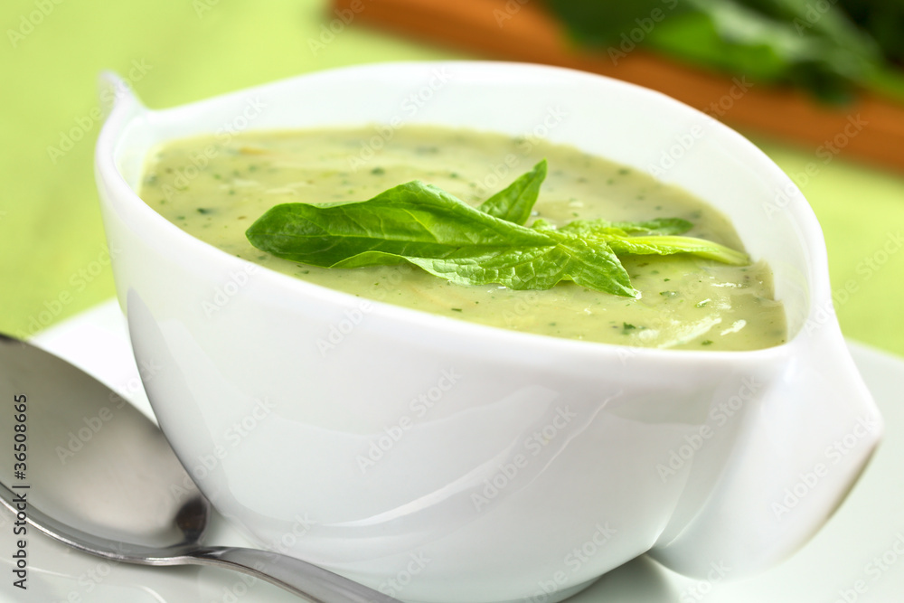 Spinach cream soup with a fresh spinach leaf on top Spinach cream soup with a fresh spinach leaf on top