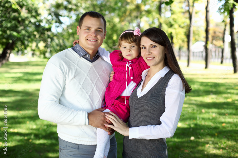 Young family with a child in summer park Young family with a child in summer park