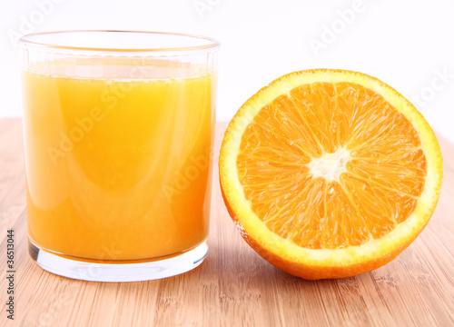 Glass of Orange juice and a half of an orange