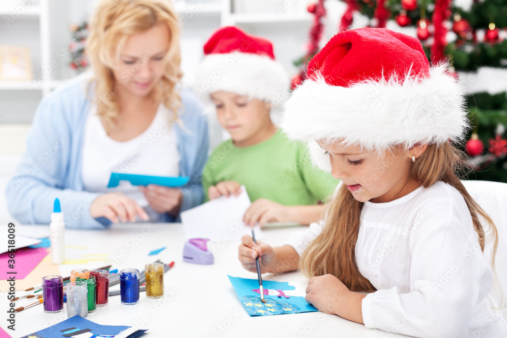 Family making seasonal greeting cards together Family making seasonal greeting cards together