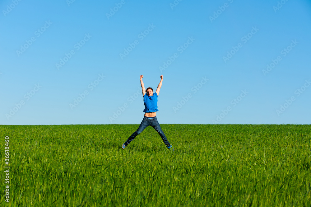 man jumping on the green field