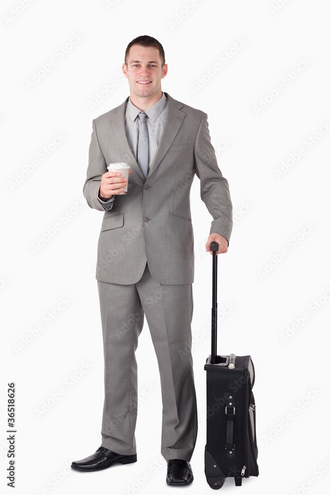 Portrait of a businessman holding a cup of tea and a suitcase Portrait of a businessman holding a cup of tea and a suitcase