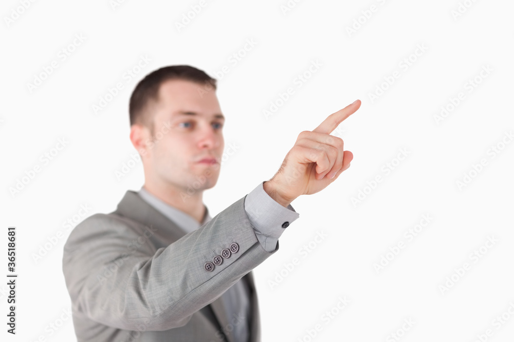 Young businessman touching something Young businessman touching something