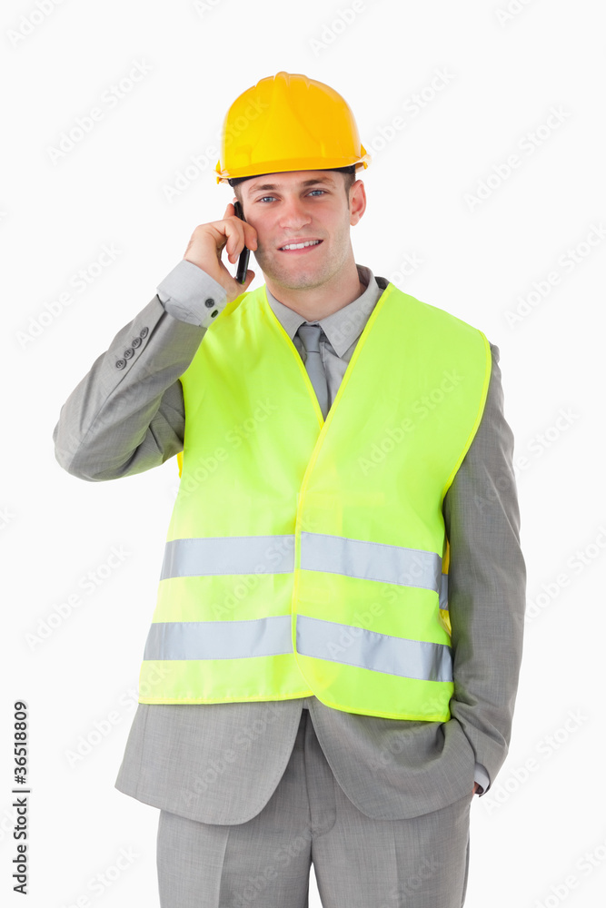 Portrait of a handsome builder making a phone call Portrait of a handsome builder making a phone call