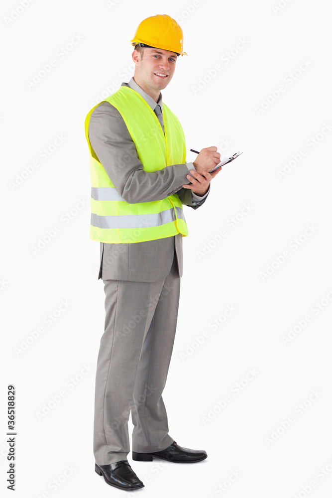 Portrait of a smiling contractor taking notes Portrait of a smiling contractor taking notes