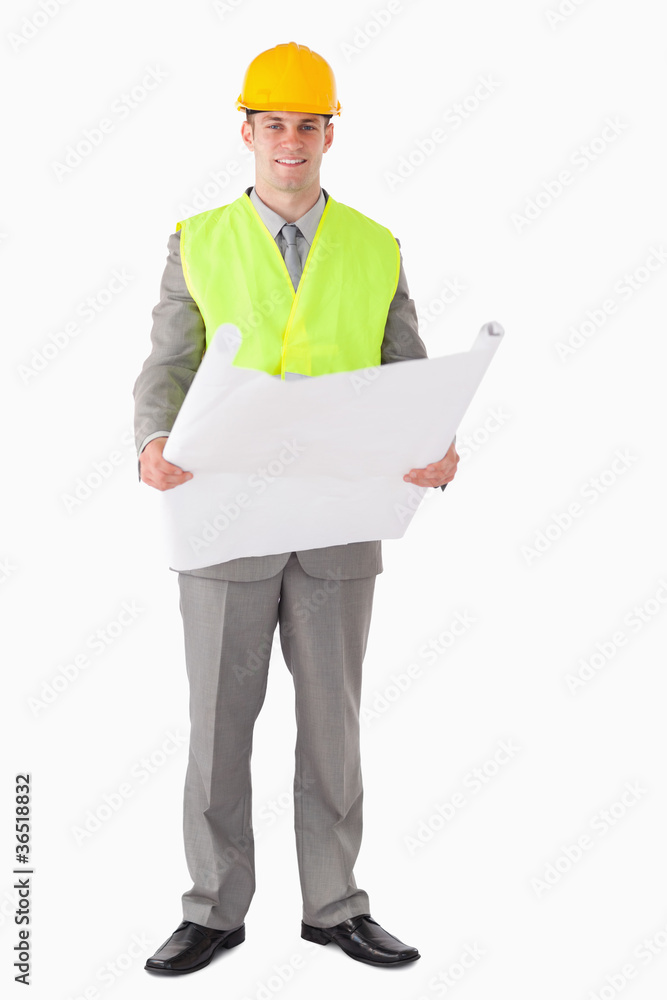 Portrait of a smiling architect looking a plan Portrait of a smiling architect looking a plan