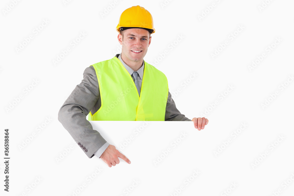 Smiling builder pointing at something Smiling builder pointing at something