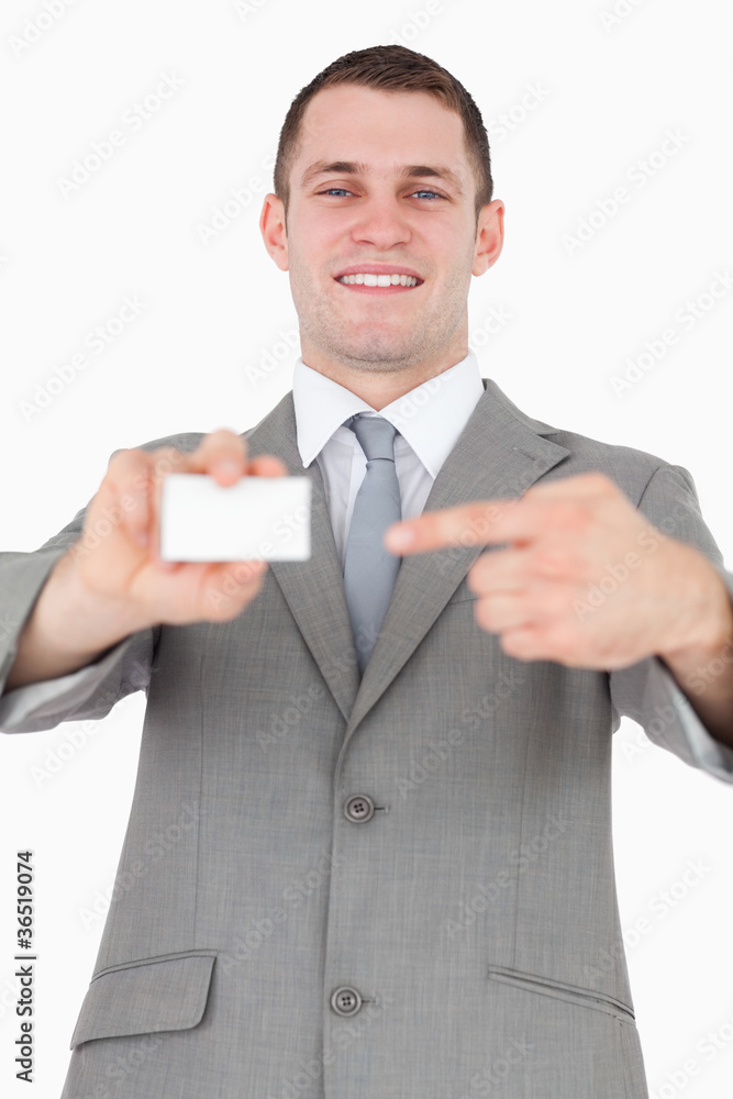 Portrait of a businessman pointing at a blank business card Portrait of a businessman pointing at a blank business card