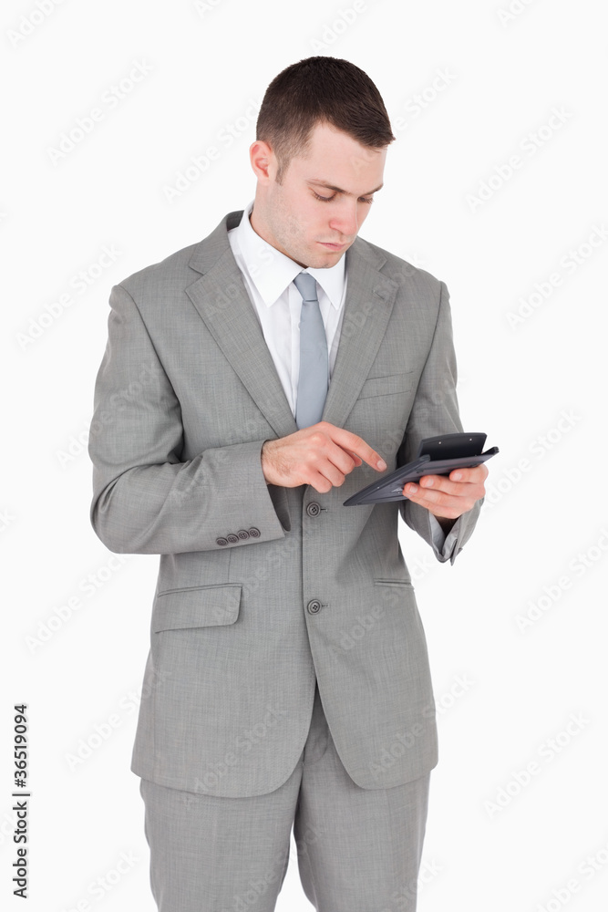 Portrait of a businessman working with a calculator Portrait of a businessman working with a calculator