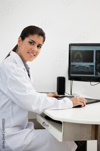 Female dentist working on computer