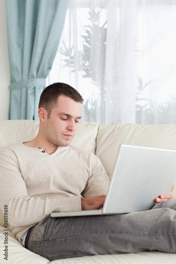 Portrait of a man relaxing with a laptop Portrait of a man relaxing with a laptop