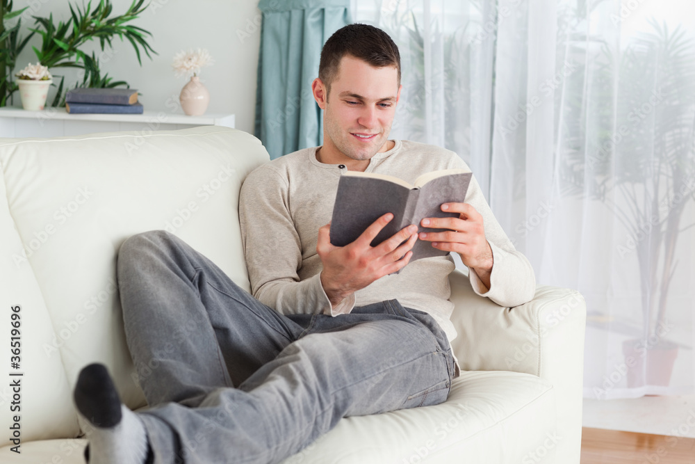 Smiling man reading a book Smiling man reading a book
