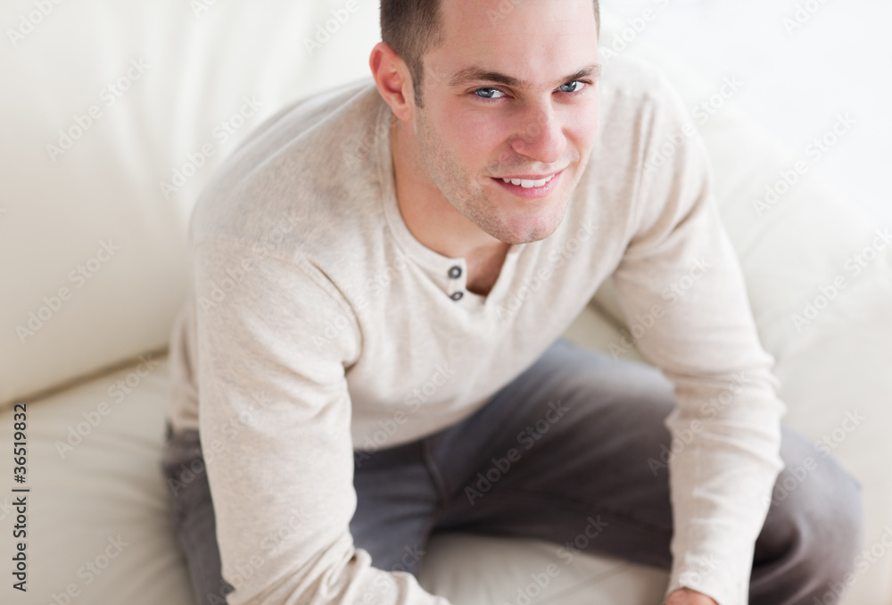 Handsome man sitting on a couch Handsome man sitting on a couch