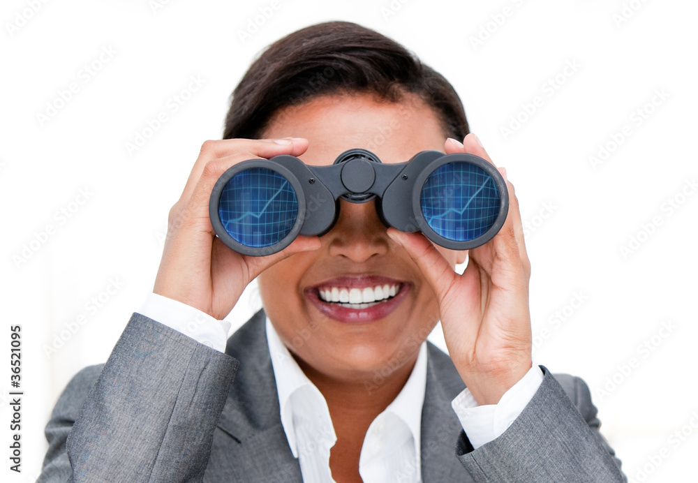 Assertive businesswoman looking through binoculars Assertive businesswoman looking through binoculars