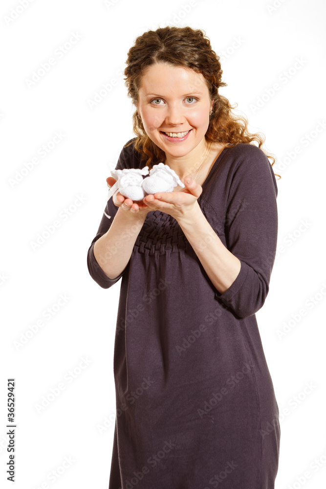 Beautiful pregnant woman with baby bootees on white Beautiful pregnant woman with baby bootees on white