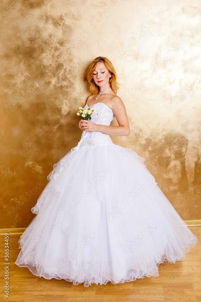 Beautiful red haired woman in white bridal dress Beautiful red haired woman in white bridal dress