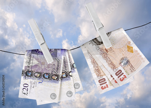 UK pounds dry on washing line pegs- financial metaphor