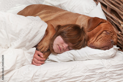Girl and her dog in the bed