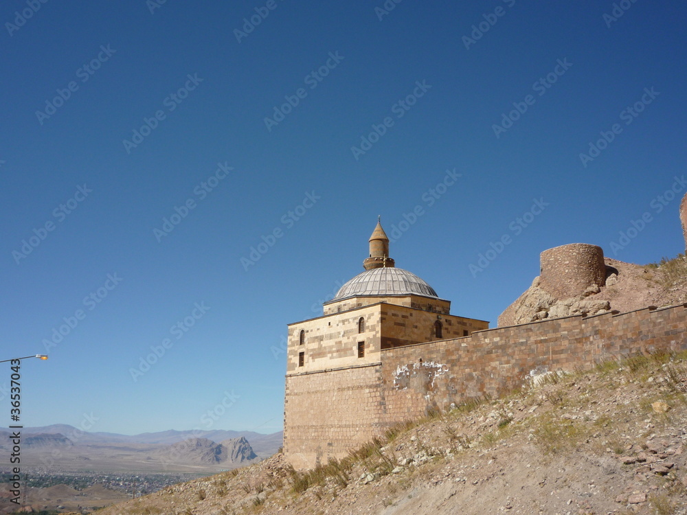 dome building Ishak Pasha Palace in eastern turkey over looking plain.