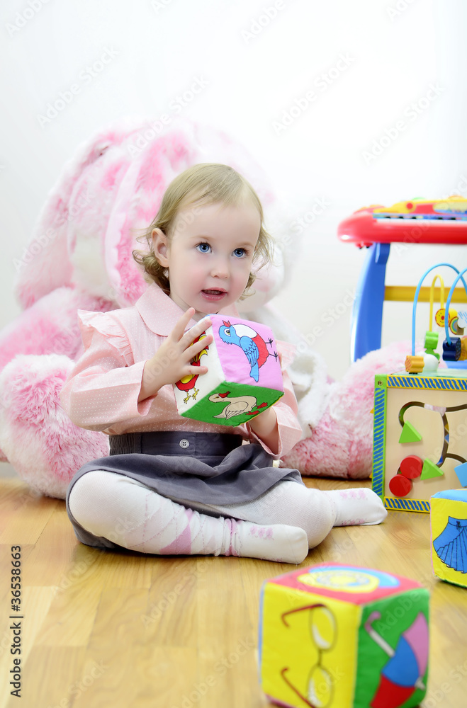 little girl in a room with toys little girl in a room with toys