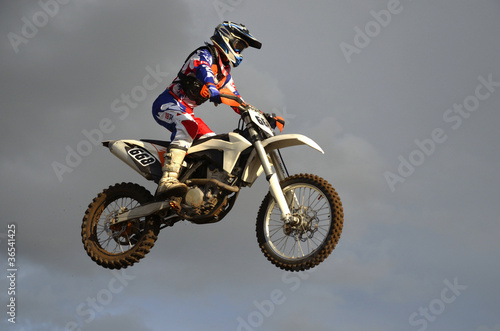 The spectacular jump motocross racer on a motorcycle