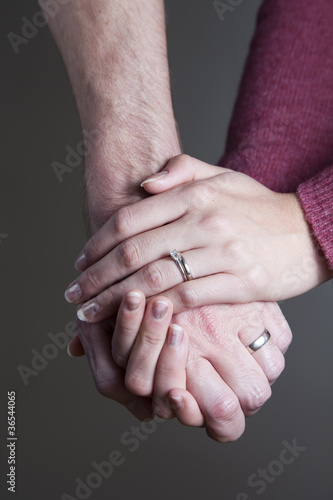 A married couple holding hands.