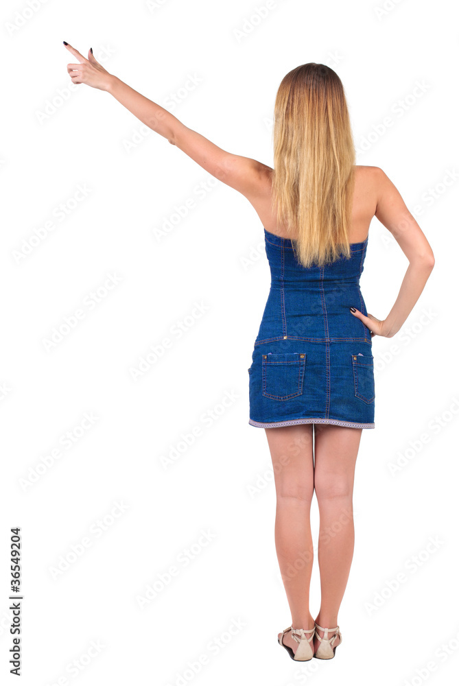 back of view beautiful young woman in jeans dress pointing at w back of view beautiful young woman in jeans dress pointing at w