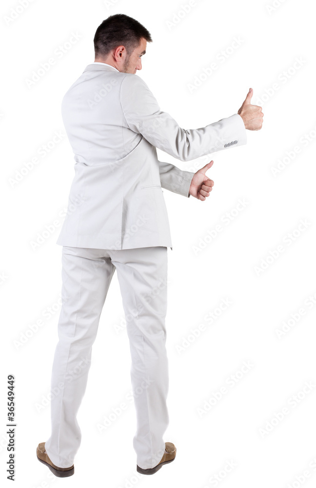 Back view of young business man in white suit going thumb up Back view of young business man in white suit going thumb up