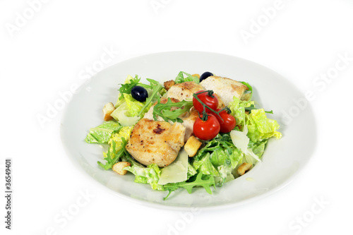 Caesar salad with chicken steak on white background